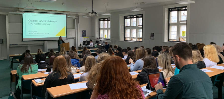 Colour photo of pupils and teachers listening to a sample lecture at the 2022 Theology and Religious Studies Discovery Day