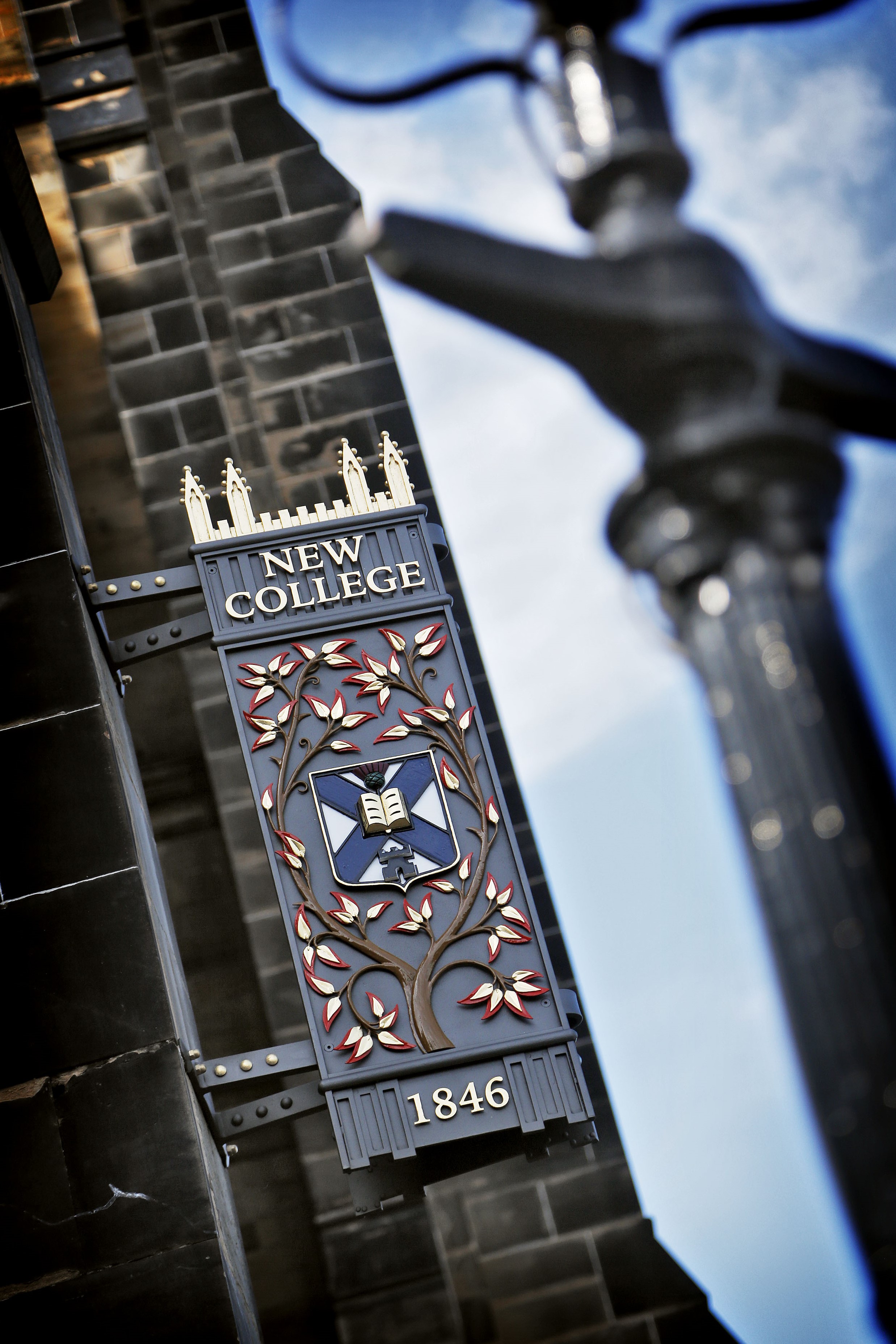 Colour photo of the New College sign